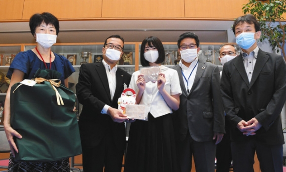手作りマスクを手渡した河合さん(左から3人目)ら=昭和区の桜花学園高で
