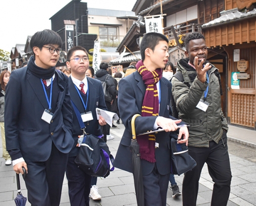 留学生（右端）を英語で案内する中学生ら＝伊勢市のおはらい町通りで