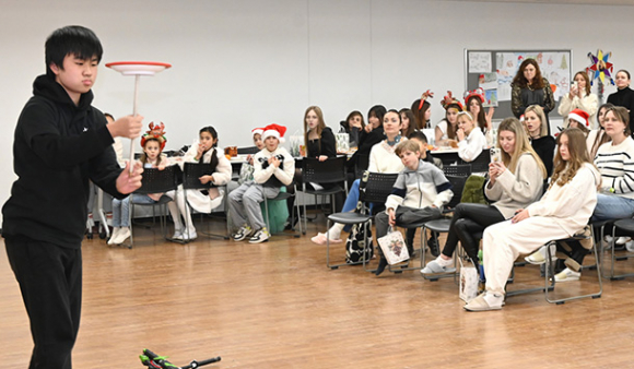 ウクライナ人らに皿回しを披露する奇術部の生徒＝昭和区の南山高等・中学校男子部で