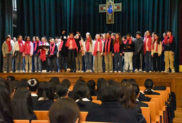 南山中女子部の合唱祭で歌声を響かせるランス大聖堂合唱団＝昭和区五軒家町の南山学園講堂で