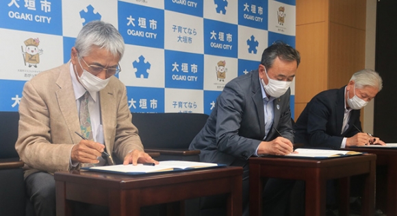 協定書に署名する曽根学長（左）ら＝大垣市役所で
