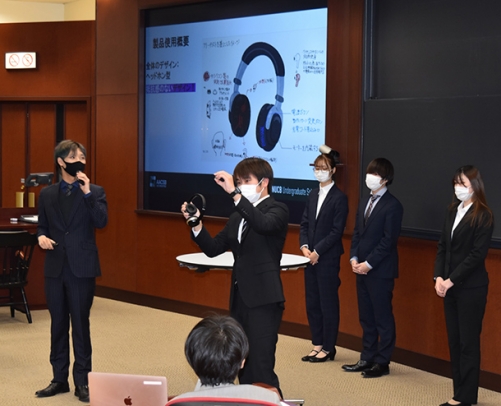 試作品を見せながらビジネスプランを発表する学生たち＝日進市の名古屋商科大で