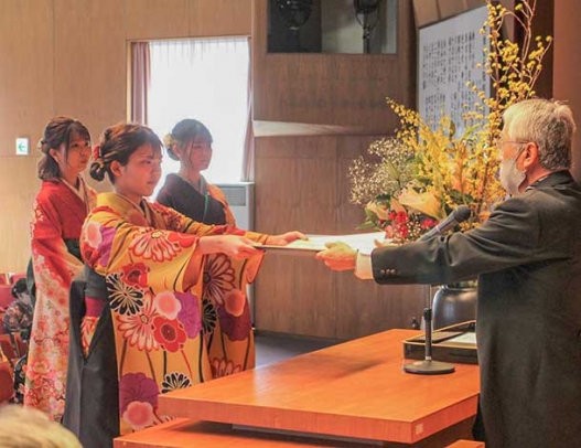 曽根学長（右）から卒業証書を受け取る卒業生＝大垣市の大垣女子短大で