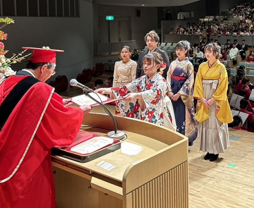 中部学院大の江馬学長から学位記を授与される卒業生代表＝岐阜市長良福光の長良川国際会議場で