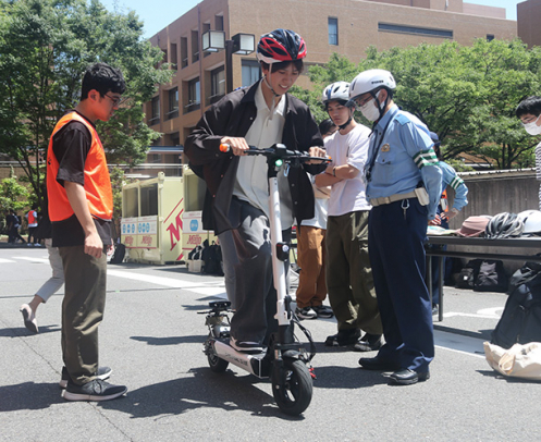 電動キックボードの運転を体験する学生＝天白区の名城大で