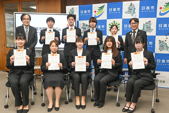 認定書を受け取った学生たちと近藤市長（上段右端）、松岡教授（上段左端）＝日進市役所で
