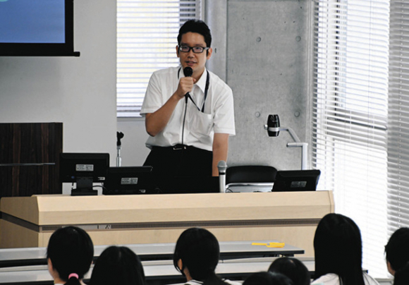 サイバー犯罪捜査官の仕事について紹介する春日井さん=長久手市の県立大で