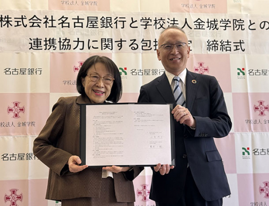 協定書を手にする金城学院の小室理事長（左）と名古屋銀行の藤原頭取＝守山区の金城学院大で