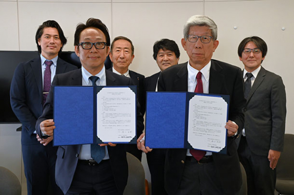協定を結んだ鈴木委員長（前列右）や清水学長（前列左）ら関係者＝豊橋市役所で