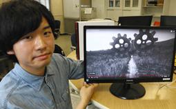 希望と絶望を題材にした受賞作「ＨＡＧＵＲＵＭＡ」を紹介する鈴木さん＝稲沢市の名古屋文理大で