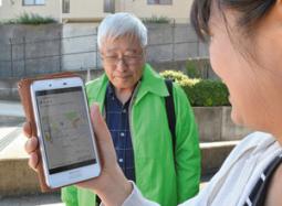 スマートフォンのＧＰＳ機能を使い、認知症高齢者役（左）を捜して声掛けする訓練＝名東区の愛知東邦大で