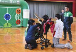 学生らのサポートを受けて的を狙う生徒（中）＝関市桐ケ丘の関特別支援学校で